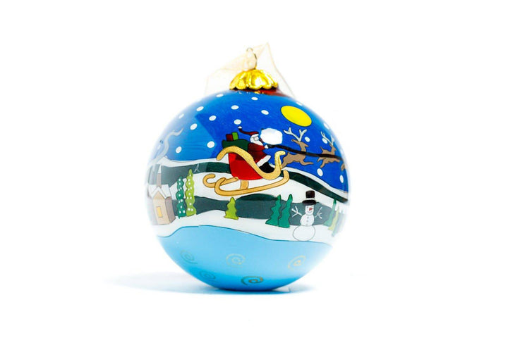 Santa in Sleigh Flying Over Winter Scene Round Hand-Painted Glass Christmas Ornament